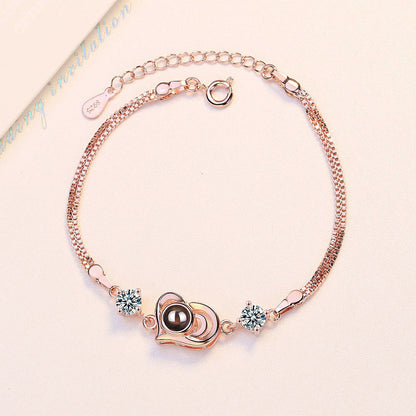 Pulsera con proyección de fotos y forma de corazón de circonitas 