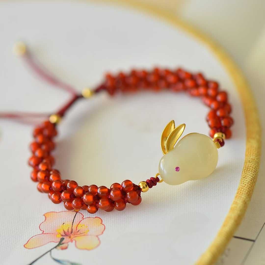 Close-up of lucky rabbit carving on Hetian jade bracelet - traditional symbol
